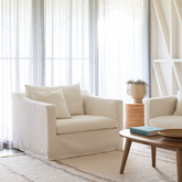 Ayla Armchair in Vintage Cream loose cover styled in a minimal living room with soft light